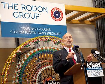 tom wolf speaks at a podium in the Rodon facility