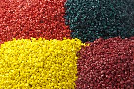 piles of red, yellow, and green resin pellets