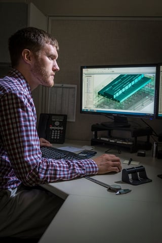 Rodon employee examines an injection mold design on the computer