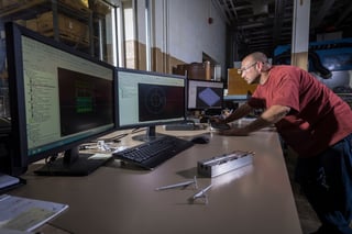 Rodon employee examines designs on computer