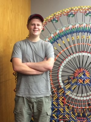 Rodon Intern Garret Rees stands in front of large ferris wheel made of k'nex